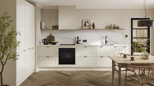 A shaker, porcelain kitchen in an in-frame peninsula layout from the Frome range. It has oak flooring & green wall cabinets.