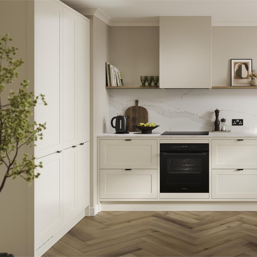 A shaker, porcelain kitchen in an in-frame peninsula layout from the Frome range. It has oak flooring & green wall cabinets.