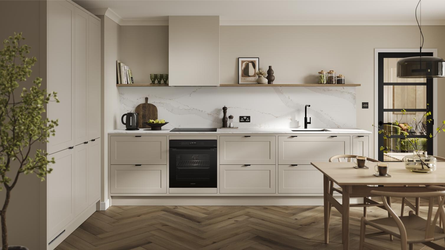 An in-frame shaker, sandstone kitchen in peninsula layout from the Frome range. It has oak plank flooring & green wall units