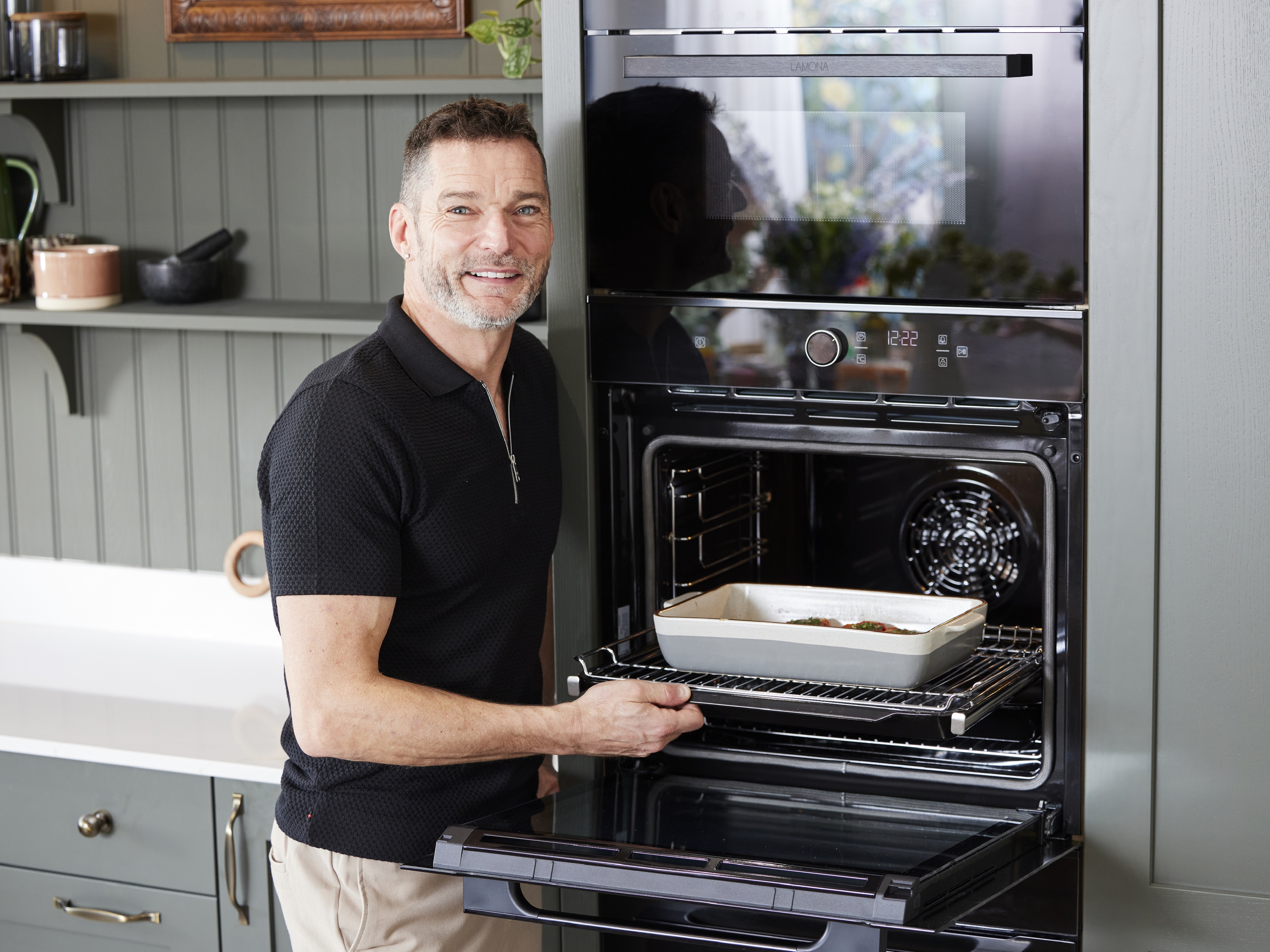 Fred posing and putting a dish into one of his new Lamona ovens