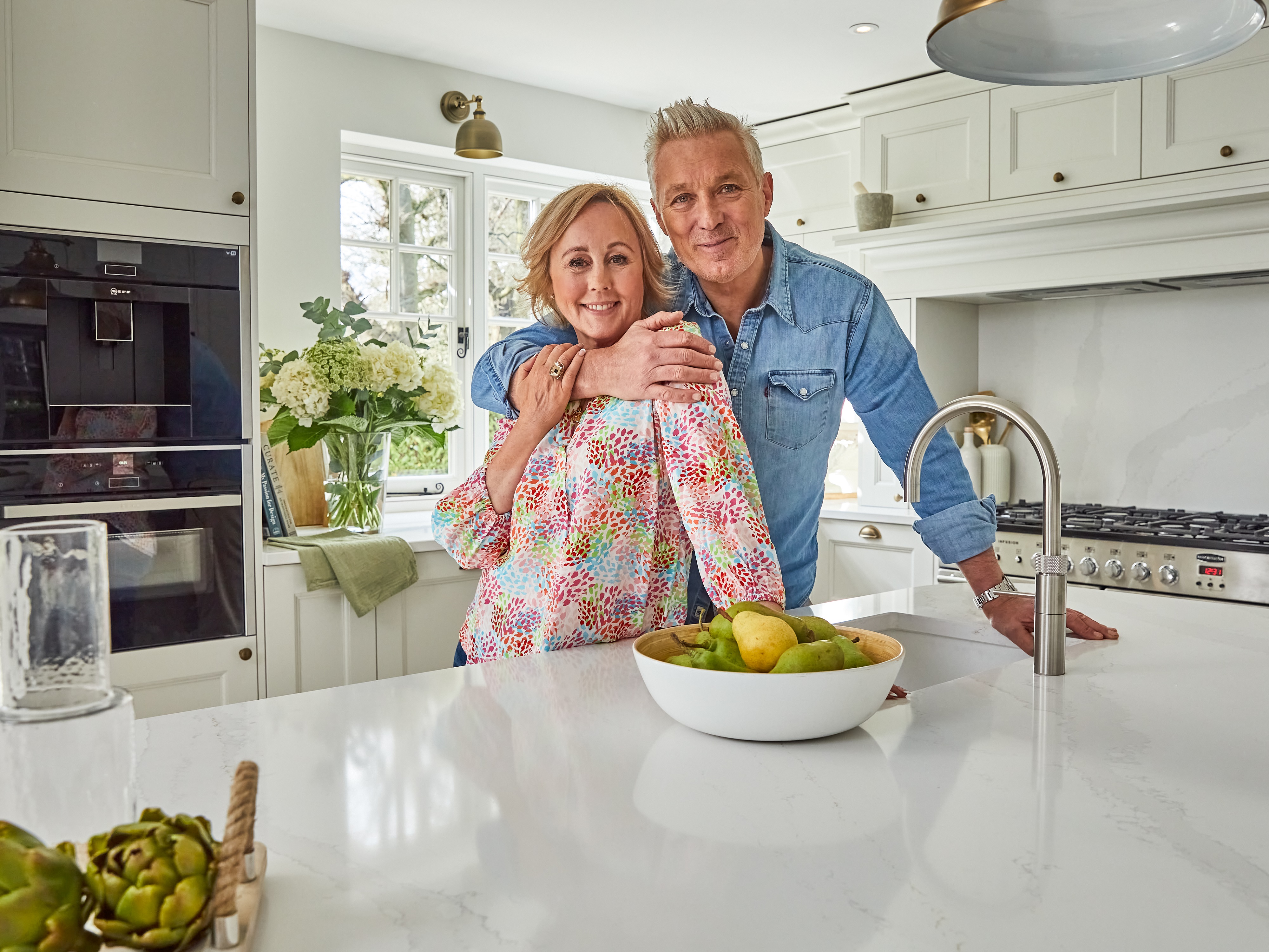 Martin and Shirlie posing together in their new kitchen