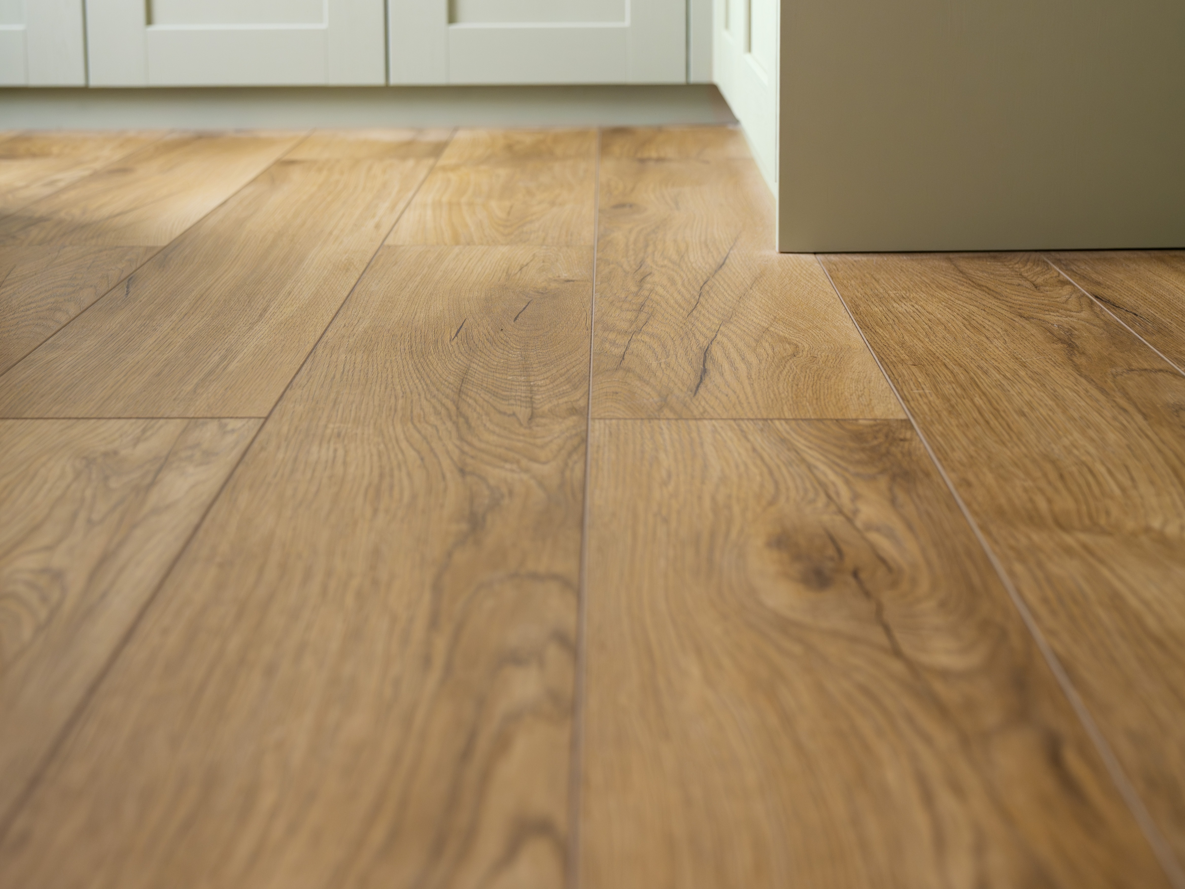 Plank flooring alongside green bedroom units