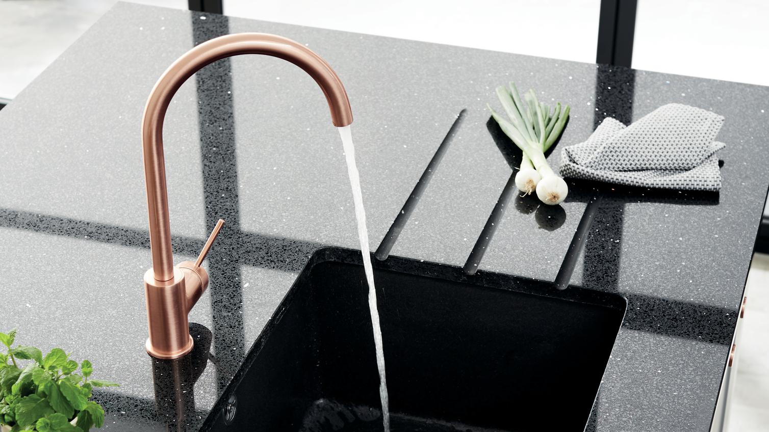 A black, bespoke sink and worktop