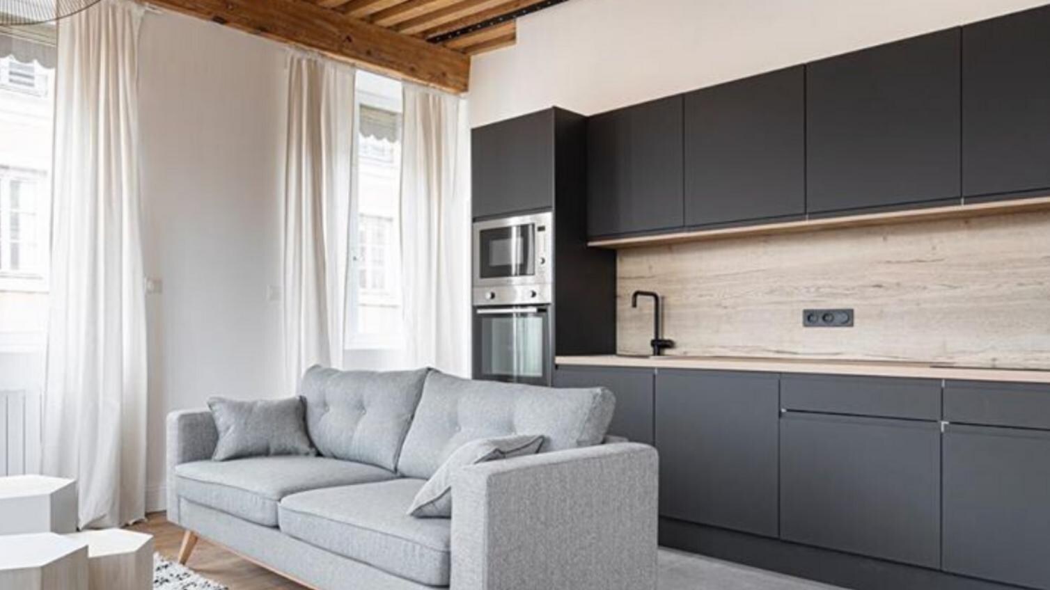 matt black kitchen with integrated handle doors and light oak worktops