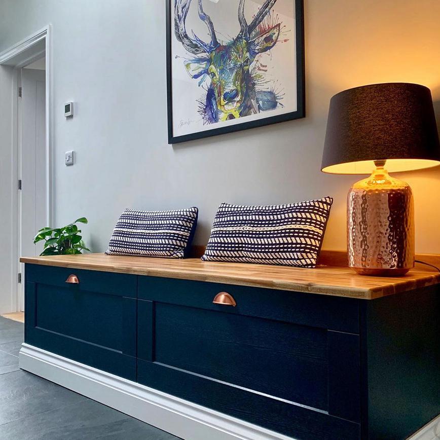Combining deep drawers with a countertop for a boot room storage idea that creates a comfy bench.