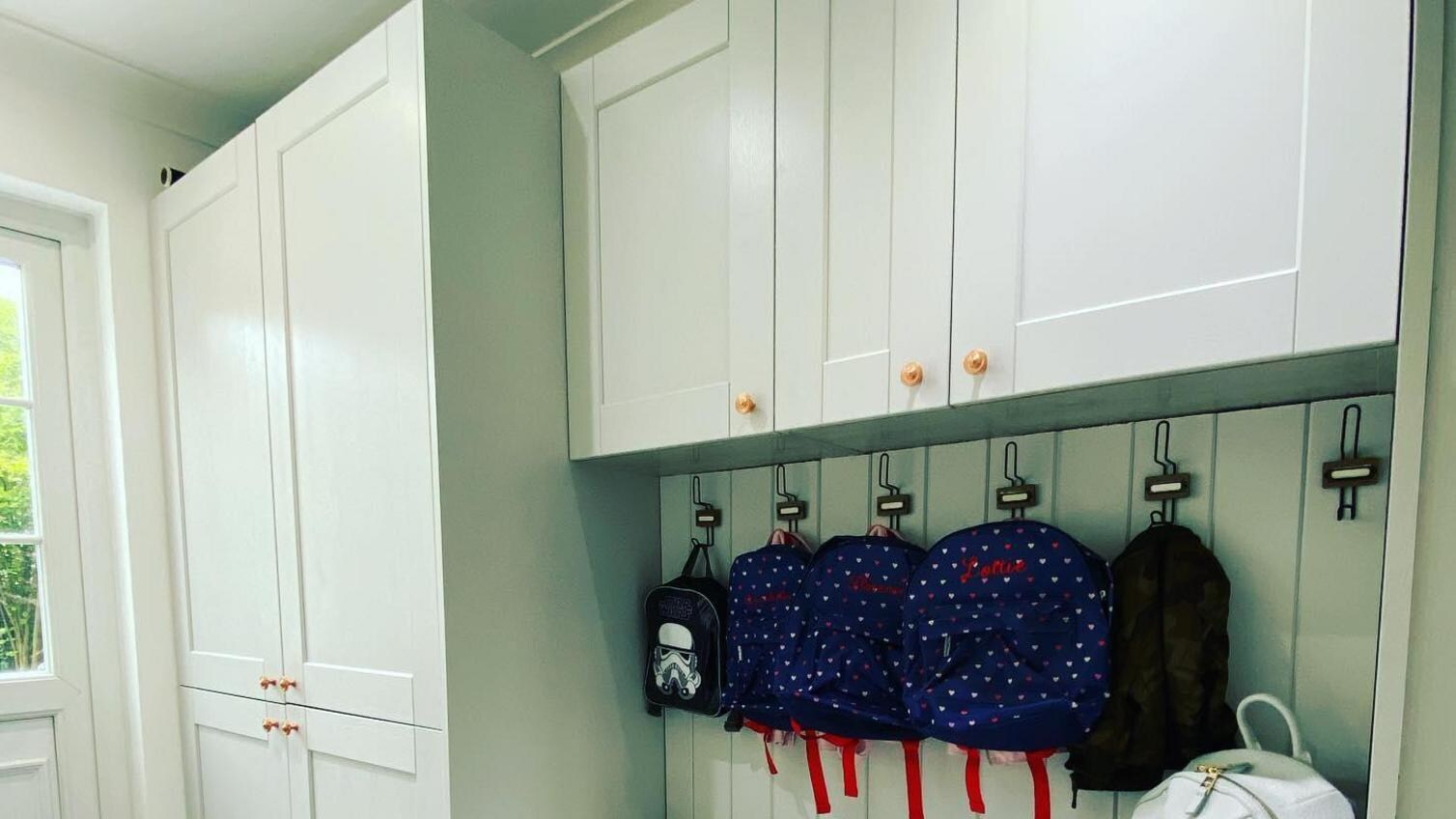 Boot room storage idea using different depths of cabinets to create a spacious seating area.