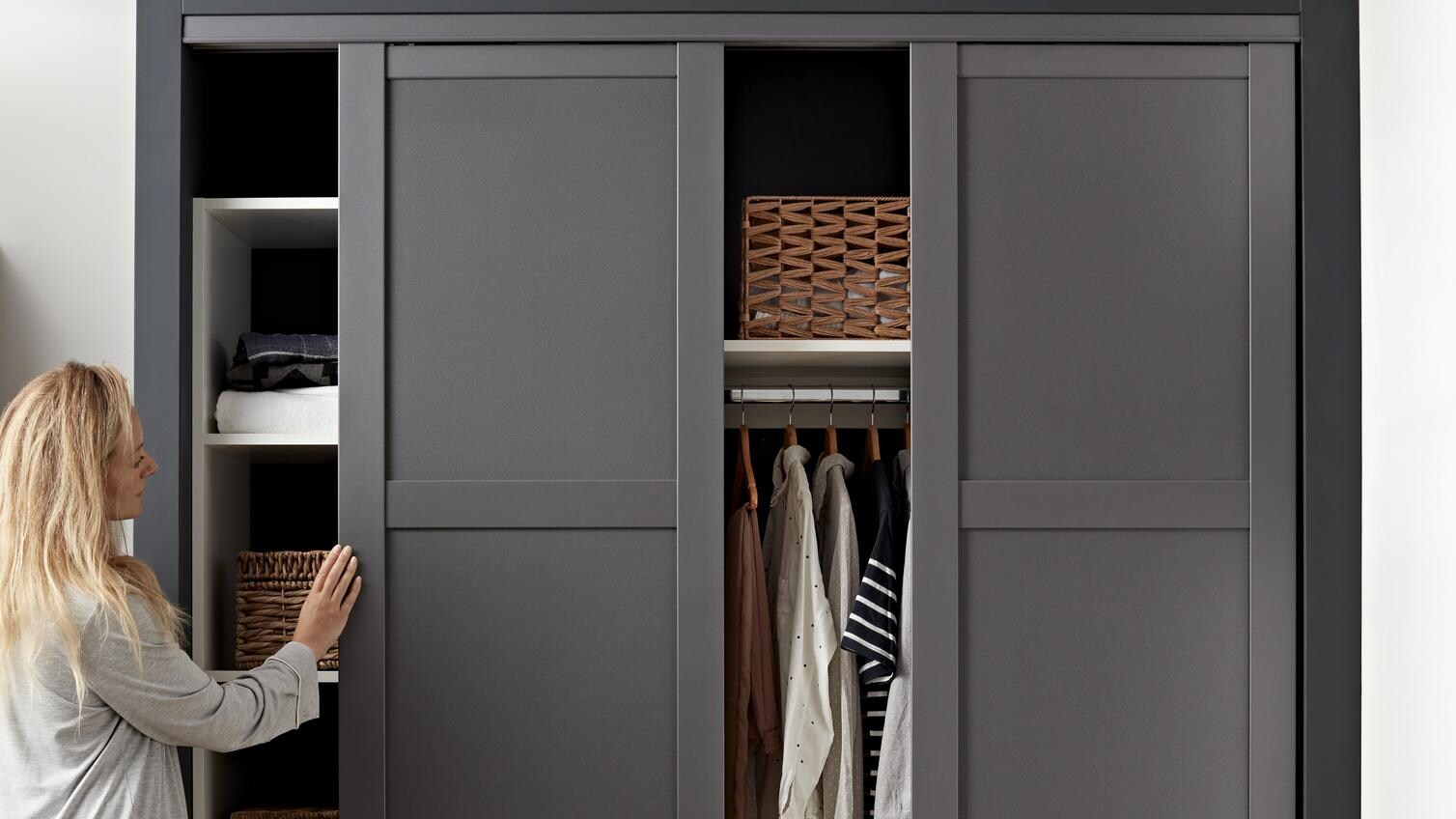 Built in wardrobe with sliding wardrobe doors in a framed, grey design.