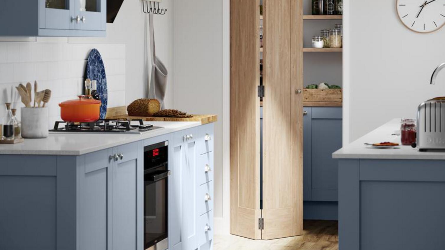 A bifold door in a white and blue kitchen