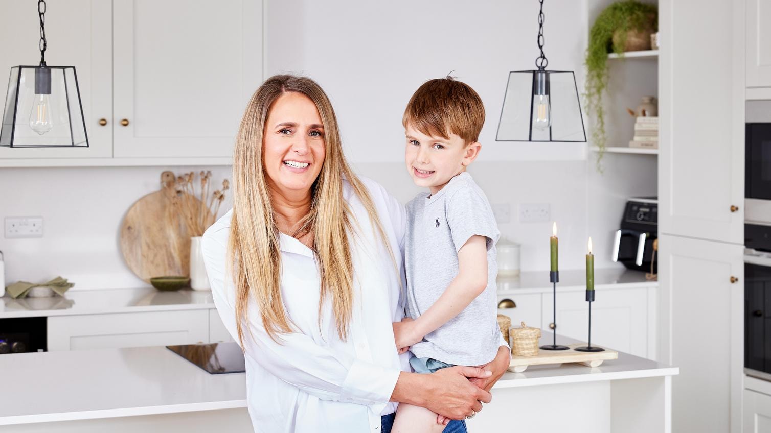 Serena and her son preparing a meal together on their white Howdens island worktop