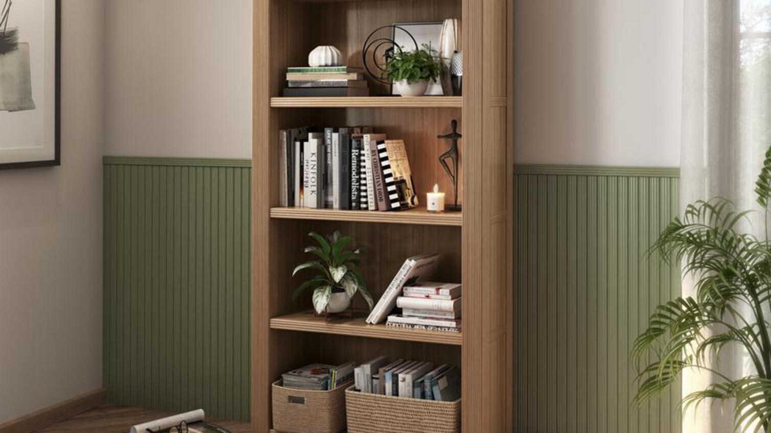 A timber bookcase in a room with herringbone flooring and green reeded mouldings