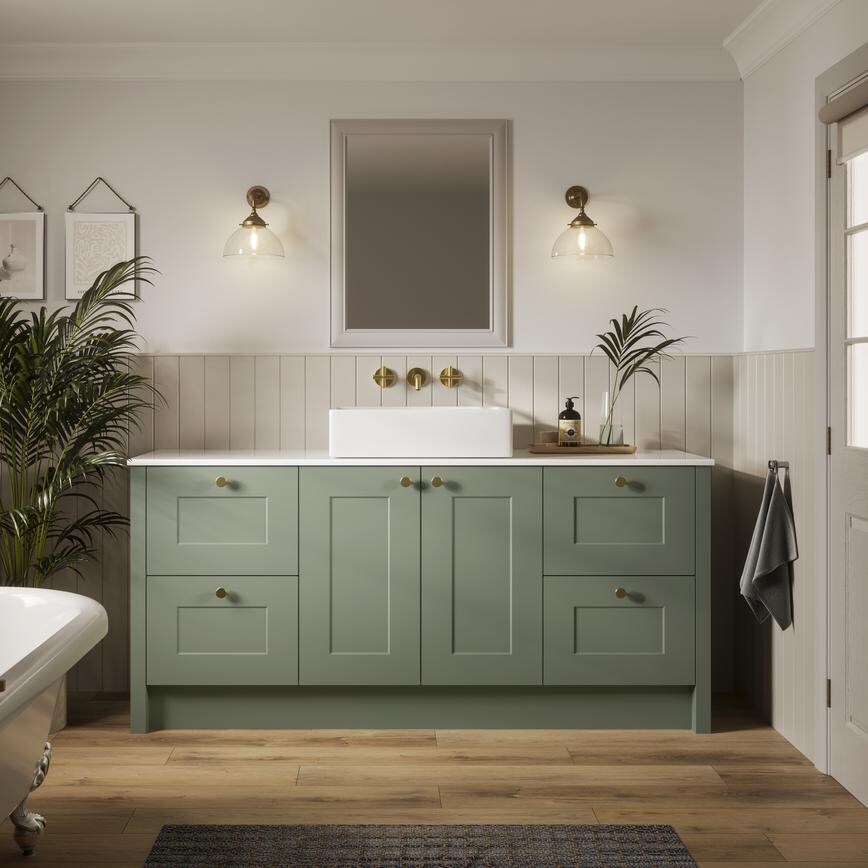 A Chelford reed green bathroom with shaker cabinets and vanity unit. Also includes oak-style flooring and roll top bath.