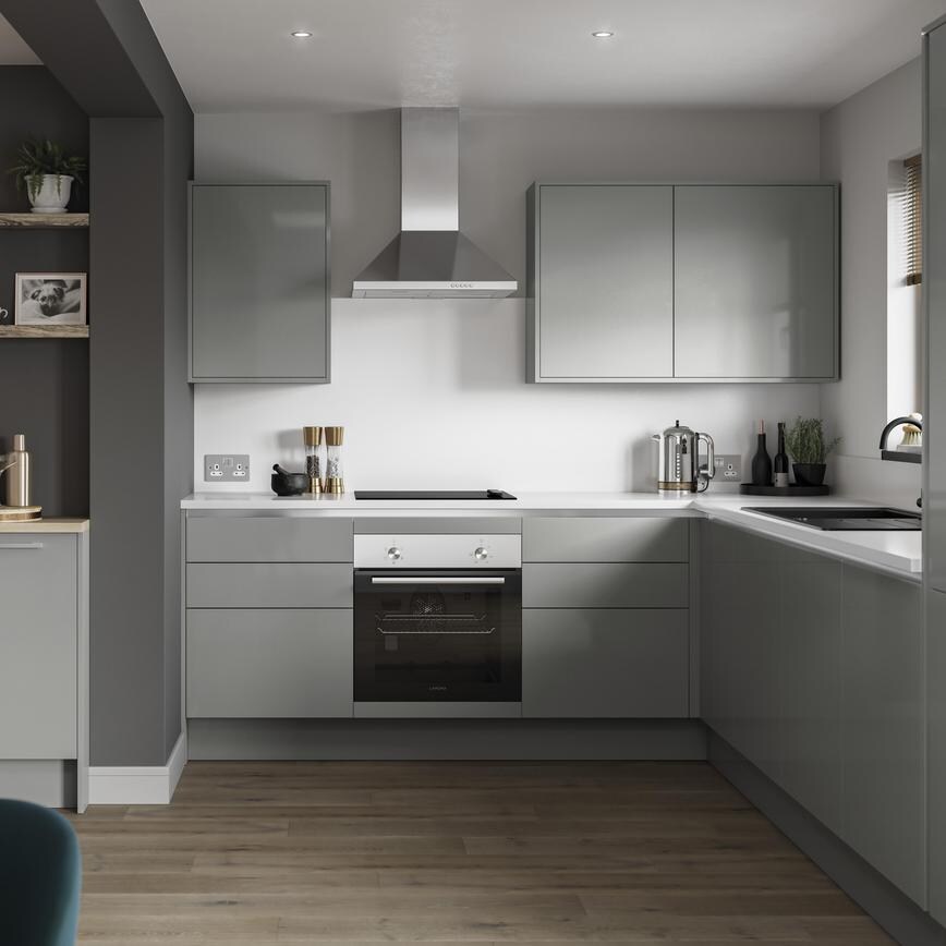 Small l-shape kitchen with grey slab doors and copper trims for a handleless look. Has a single oven and a silver extractor.