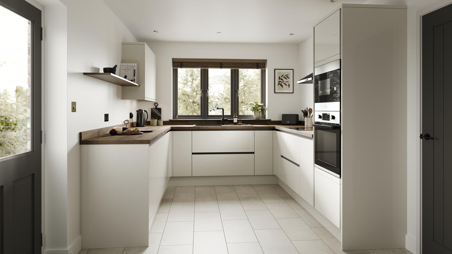A porcelain, slab kitchen in a gloss finish and u-shaped layout. It has dark worktops, handleless doors and black profiles. 