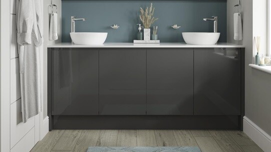 Charcoal bathroom with gloss cupboard doors. Includes a white square-edged worktop, two white basins, and silver lever taps.