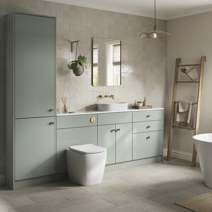 A reed green bathroom with a gloss finish and brass handles. It has contemporary stone-effect flooring and wall tiles. 