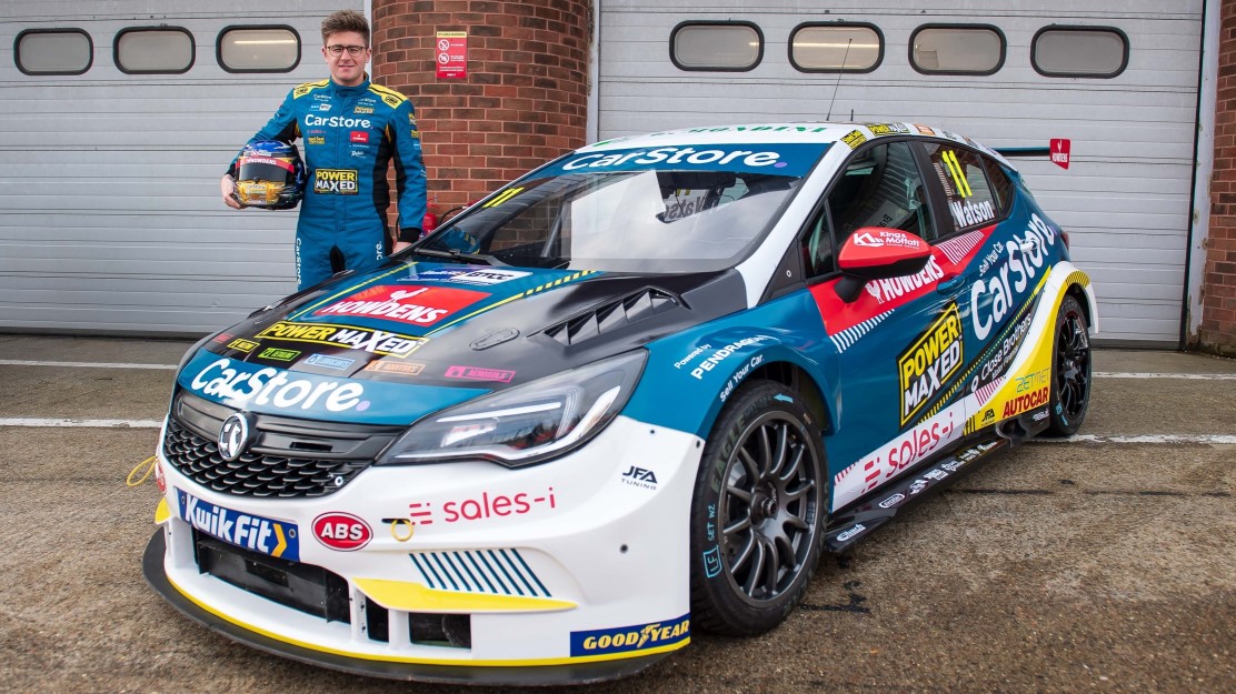 Andrew Watson stood beside a Vauxhall car that features Howdens advertising